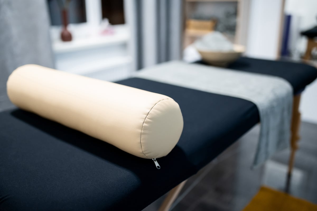 massage table with towels, head pillow in the massage room